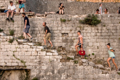 Tourists explore the fortifications of Kotor, a coastal town of Montenegro. In 2016 it was added to Lonely Planet's list of the top ten places to visit in the world.