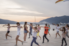 Teenaged cheerleaders do a rehearsal on the waterfront of Tivat, in the central part of the Bay of Kotor in Montenegro, Originally a small fishing village, Tivat hosts Porto Montenegro, a luxury tourism village that attracts tourists from Europe, Russia and USA. Even if the Village is formally open (no walls and barriers), the prices of its products and services are so high that the majority of the local population feels excluded from Porto Montenegro.
